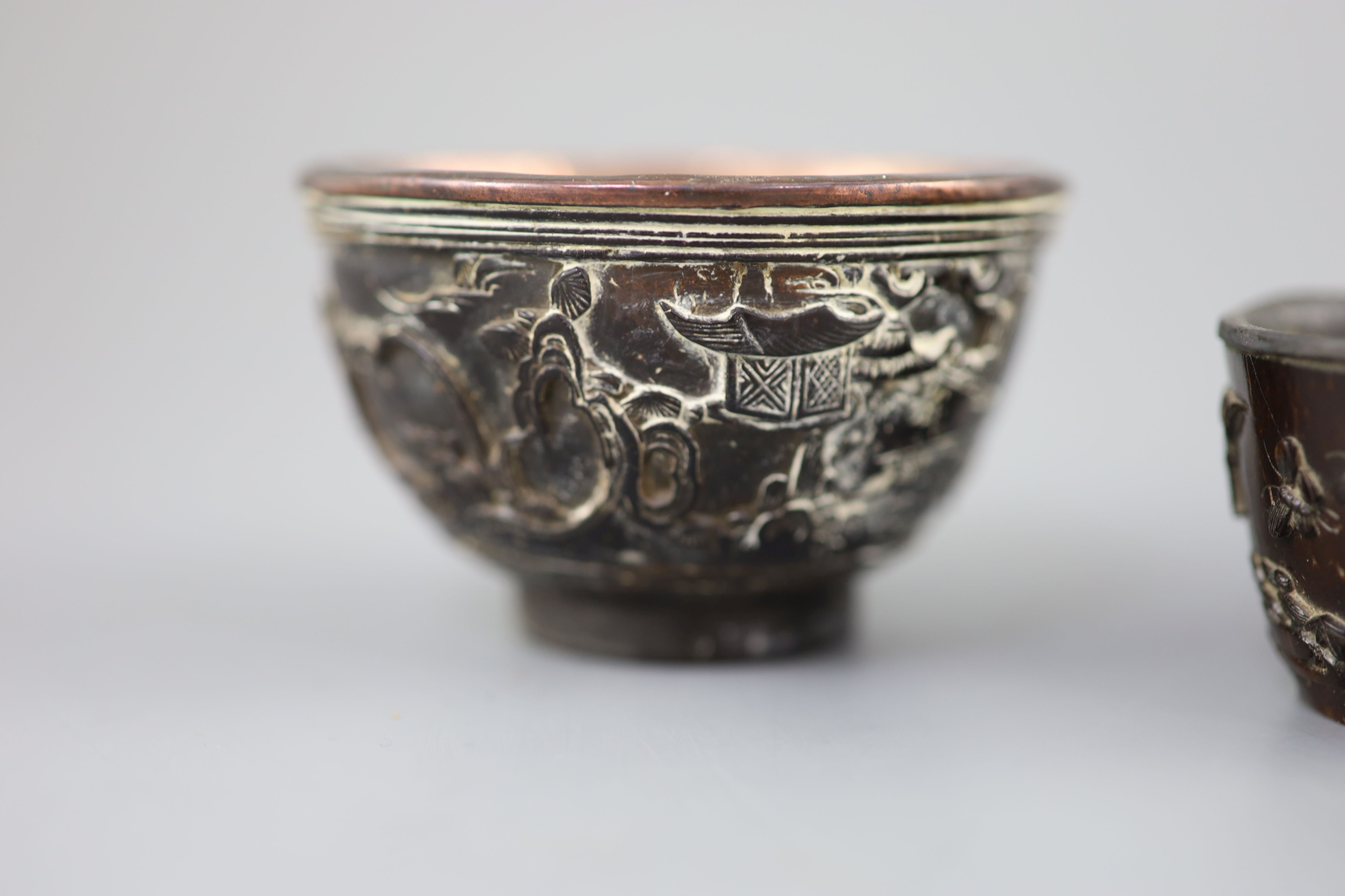 A pair of Chinese coconut landscape cups and a similar peach-shaped cup, 18th/19th century,